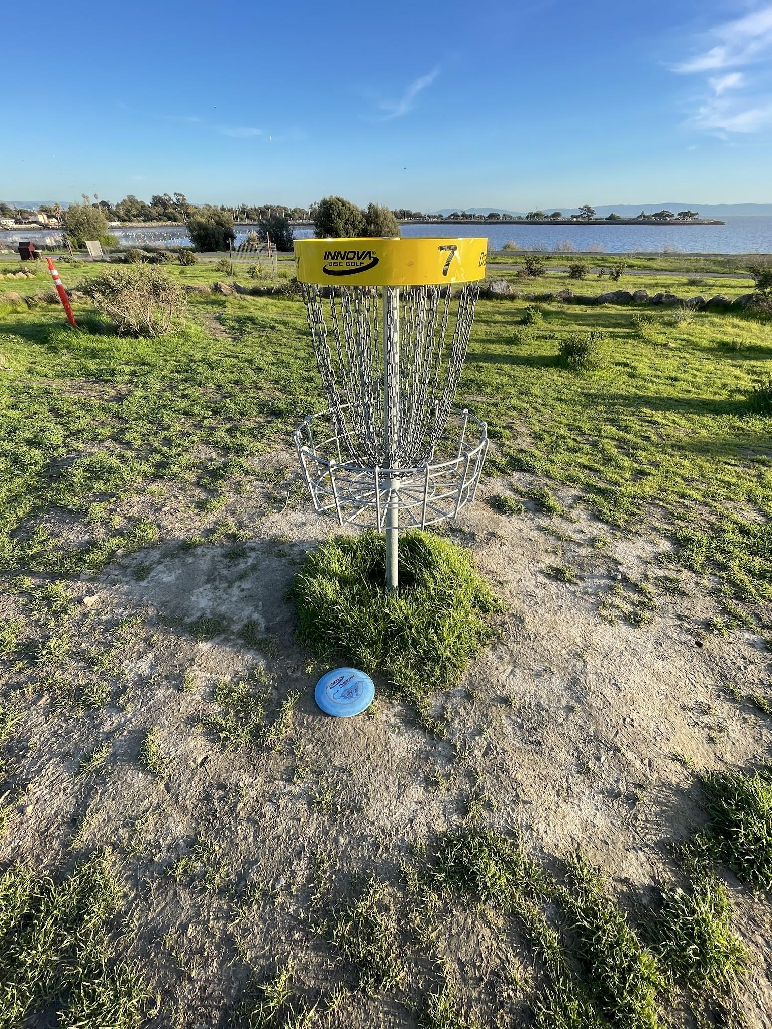 Yellow basket seven with green fairways and shoreline views at Oyster Bay